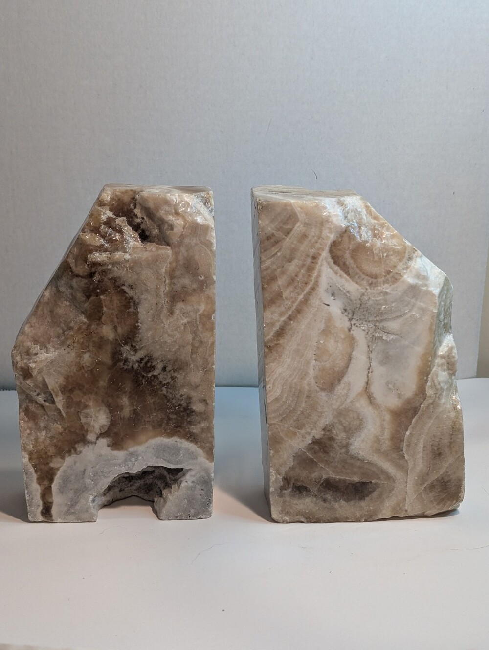 A pair of natural banded calcite or onyx agate stone bookends.